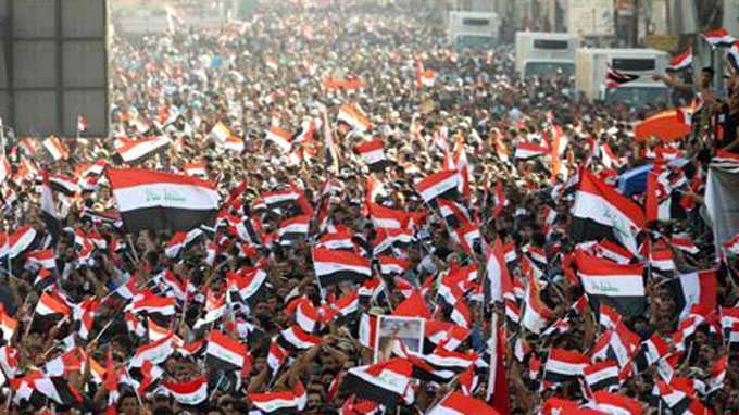 Thousands of Iraqis have defied a protest ban and rallied in the heart of the capital, Baghdad, to demand an end to sectarianism and corruption.