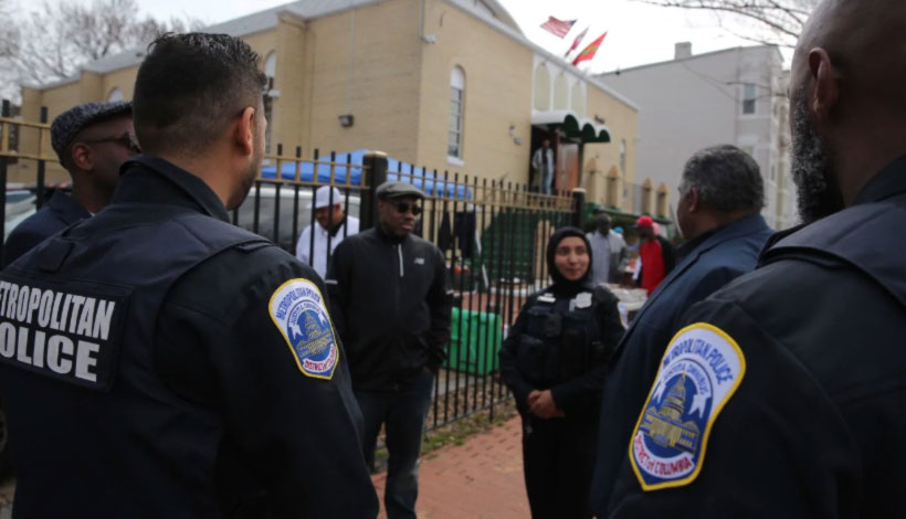 D.C. police officers stand guard at Masjid Muhammad mosque on Friday. (Oliver Contreras/for The Washington Post)